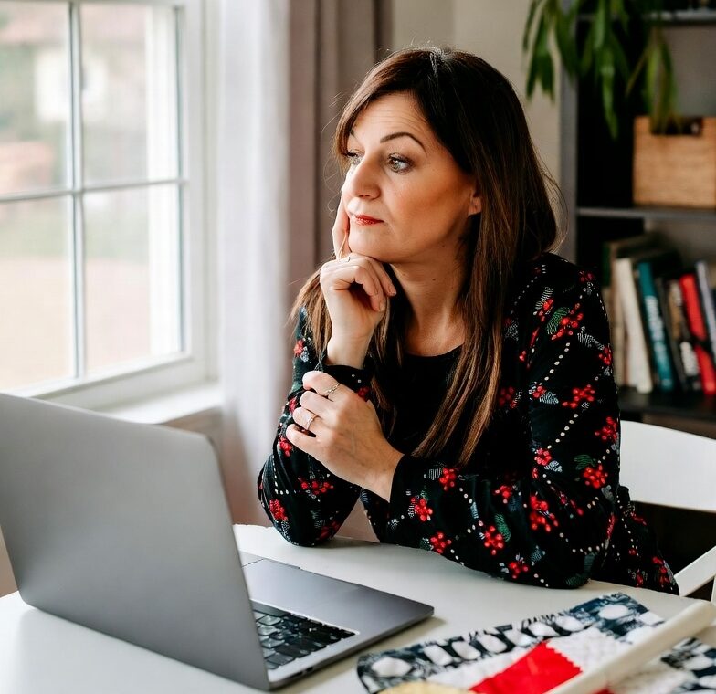 Quilter working on a laptop at a table